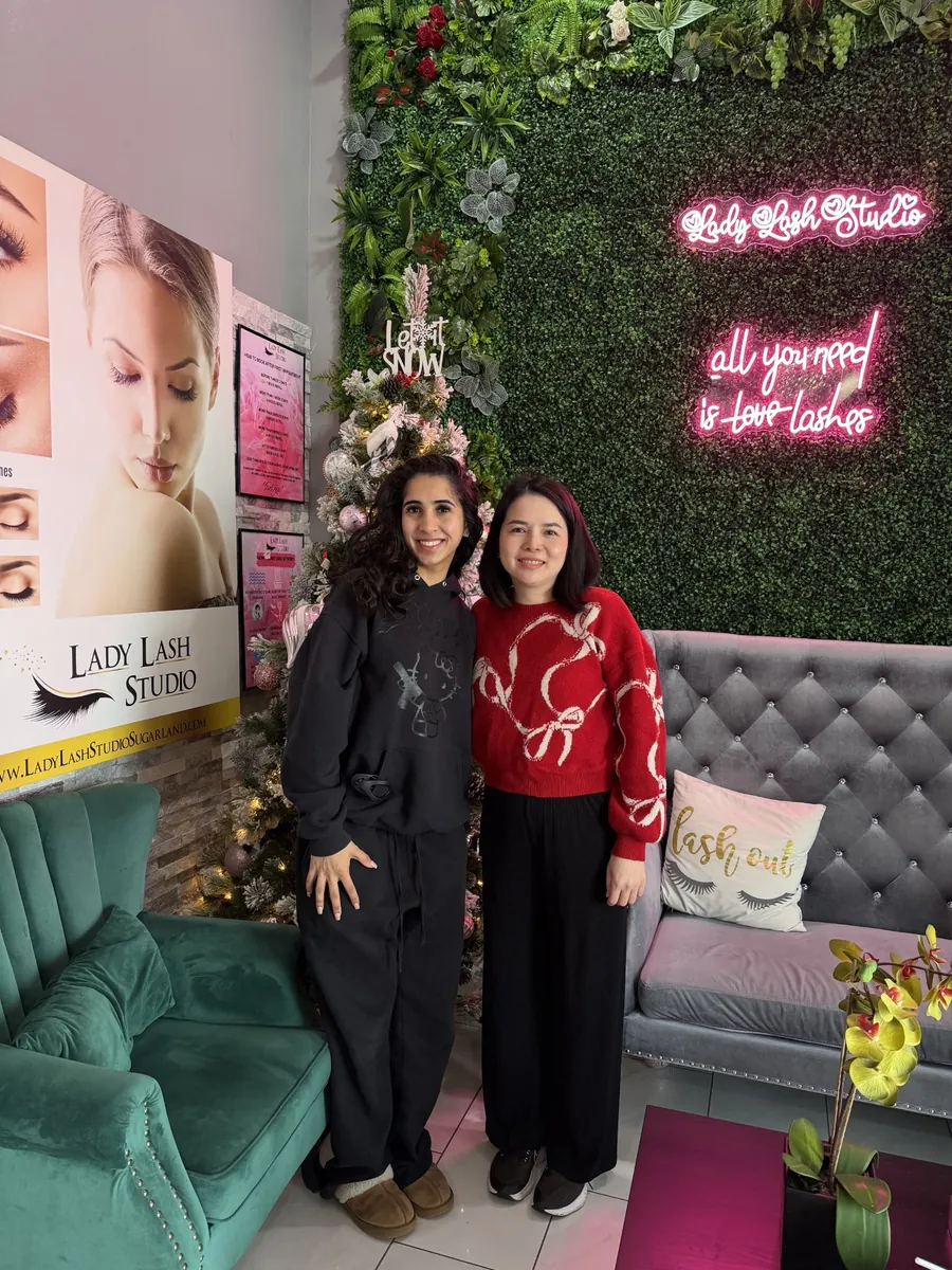Lady Lash Studio team members by the neon sign in Sugar Land, TX